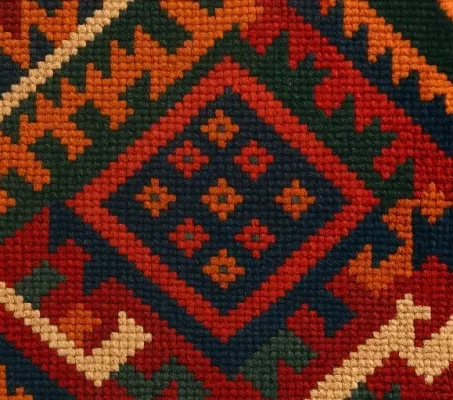 Close-up-of-a-handwoven-Iranian-kilim-showing-intricate-geometric-patterns-and-natural-wool-colors-1.webp