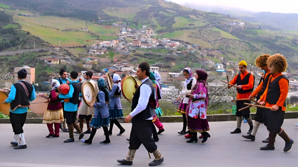A group of Mazanderani people, including men and women, wearing colorful traditional clothing