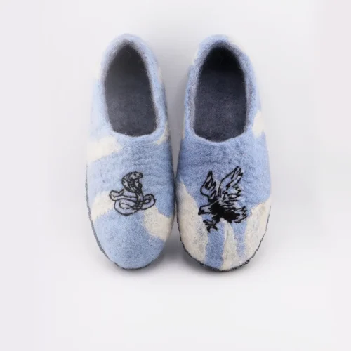 Close-up of sky blue wool slippers with reinforced toe