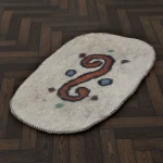 Handmade Turkmen felt rug with orange swirl and multicolor dots on natural wool base