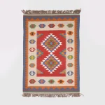 Full view of reversible Luri kilim rug with red field and Guli-Guli medallions