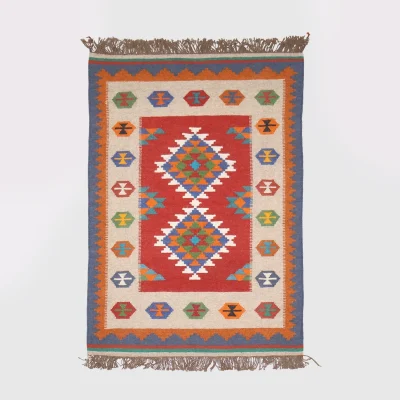 Full view of reversible Luri kilim rug with red field and Guli-Guli medallions