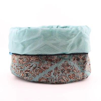 Drawstring Termeh pouch fully open showing pale sky-blue satin lining