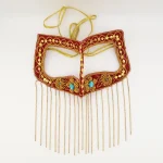 Close-up of gold zari hand embroidery and turquoise stones on authentic Bushehr Bandari burqa