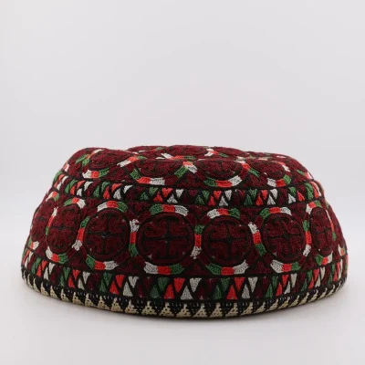 Full view of 70-year-old Yomut Atabay Turkmen embroidered skullcap – deep red with Boustan Gardi circles