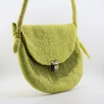 Side view showing long knotted strap and wet-felted body of Turkmen artisan wool felt bag
