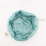 Top view of turquoise Termeh jewelry pouch with matching satin drawstring