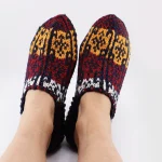 Close-up of authentic Turkmen hand-knit wool slipper socks with traditional tribal patterns