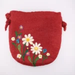 Front view of 20x20 cm handmade felt crossbody bag with floral wildflower design and knotted strap