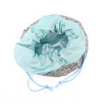 Top view of turquoise Termeh jewelry pouch with matching satin drawstring
