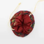 Top view of burgundy Termeh jewelry pouch with beige/off-white satin drawstring