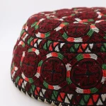 Close-up of silk chain-stitch “Boustan Gardi” garden motifs and black Tirane borders