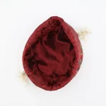 Top view of burgundy Termeh jewelry pouch with beige/off-white satin drawstring