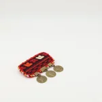 handmade Turkmen silk embroidery brooch with small dangling bronze medals on black coat
