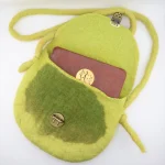 Close-up of vibrant lime green wool felt texture and seamless construction on Turkmen handmade purse