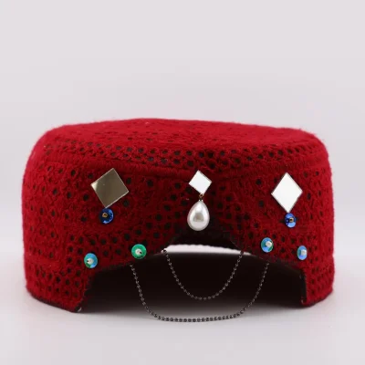 Full view of red Baluchi cap with hand-mounted mirror work and hanging chain