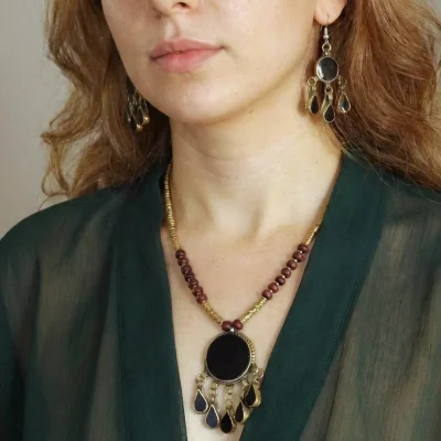 Model wearing Afghan Turkmen vintage brass tribal necklace with black teardrop pendants